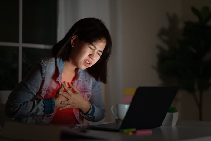 Candid Of Young Asian Woman Or Student Work Late Sitting On Desk